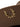 Brown cowboy hat with gold laurel wreath emblem on white background.