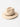 KhaanQuest Urban Grace Felted Wool Hat – Cream wool felt fedora with brown leather band and gold clasp detail.