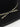 Close-up of slim black ribbon with golden leaf embroidery on wool felt cowboy hat – bohemian adventure detail
