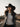 Black wool felt western hat with silver chain on road with mountains in background.