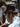 Person wearing a dark cowboy hat with a dog in the background