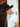 Black wool felt cowboy hat with star embellishments against rustic wooden background.